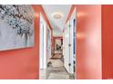 Bright coral hallway with wood-look floors and access to other rooms at 500 Fairway Village Dr. # 1-O, Myrtle Beach, SC 29588