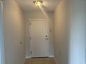 Clean and bright entryway with light flooring and a white door at 5001 Little River Rd. # W-402, Myrtle Beach, SC 29577