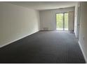 Spacious living room with wall-to-wall carpet and access to a balcony at 5001 Little River Rd. # W-402, Myrtle Beach, SC 29577
