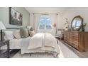 Bright bedroom with a large window, neutral color palette, and stylish dresser at 528 Duvall St., Longs, SC 29568