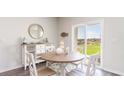Charming dining area with round table, buffet, and sliding doors offering bright light at 536 Duvall St., Longs, SC 29568