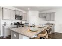 Bright kitchen featuring granite counters, stainless appliances, and a large island at 536 Duvall St., Longs, SC 29568