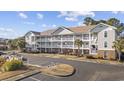 Condo building with parking and surrounding landscape at 5750 Oyster Catcher Dr. # 1124, North Myrtle Beach, SC 29582