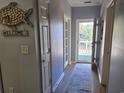 Bright hallway with doors to bedrooms and access to a balcony at 601 Hillside Ave. N # 1623, North Myrtle Beach, SC 29582