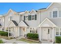 Three-unit townhome building, light taupe siding, green shutters, and landscaping at 618 3Rd Ave. S # 4D, North Myrtle Beach, SC 29582