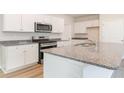 Modern kitchen with white cabinets, granite countertops, and stainless steel appliances at 632 Grateful Dr., Little River, SC 29566