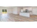 Open concept kitchen and living area with an island and wood-look floors at 632 Grateful Dr., Little River, SC 29566