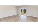 Spacious living room featuring wood-look floors and sliding glass doors at 632 Grateful Dr., Little River, SC 29566
