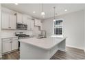 Modern kitchen featuring white cabinets, quartz countertops, and stainless steel appliances at 7015 Shooting Star Way, Myrtle Beach, SC 29579