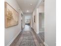 Bright and spacious hallway with wood-look flooring at 7350 Meadow Walk Loop, Loris, SC 29569