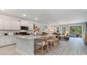 Open concept kitchen island with granite countertop, stainless steel appliances, and view of pool at 736 Rupert Dr, Conway, SC 29526