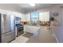 White cabinets, stainless steel appliances, and a stylish backsplash at 804 Crumpet Ct. # 1151, Myrtle Beach, SC 29579