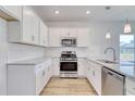 Modern kitchen with white cabinets, granite countertops, and stainless steel appliances at 888 Agostino Dr., Myrtle Beach, SC 29579