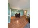 Bright dining room with wood floors and green walls at 8885 Grove Park Dr. # F, Surfside Beach, SC 29575