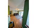 Spacious living room with wood floors and balcony access at 8885 Grove Park Dr. # F, Surfside Beach, SC 29575
