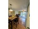 Open living room with wood floors and access to balcony at 8885 Grove Park Dr. # F, Surfside Beach, SC 29575