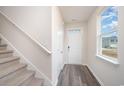 Bright entryway with stairs, coat closet, and large window at 1137 Black Lake Way, Conway, SC 29526