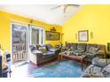 Living room with yellow walls, couches, and access to a balcony at 115 Horizon River Dr. # 8D, Myrtle Beach, SC 29588