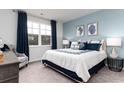 Spacious bedroom with a comfortable bed and serene blue accent wall at 1481 Nokota Dr., Conway, SC 29526