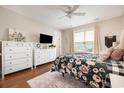 Bedroom with floral bedding, dresser, and large window at 1536 Suncrest Dr., Myrtle Beach, SC 29577