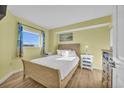 Bright bedroom with hardwood floors, a comfortable bed, and natural light from a large window at 2100 Sea Mountain Hwy. # 630, North Myrtle Beach, SC 29582