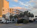 Oceanfront building with palm trees and parking at 2611 Ocean Blvd. S # 305, Myrtle Beach, SC 29577