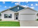 White house with blue accents and a two-car garage at 352 High Falls Dr., Conway, SC 29526