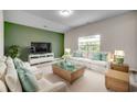 Bright living room with white sofas and green accent wall at 352 High Falls Dr., Conway, SC 29526