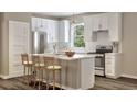 Modern kitchen featuring white cabinets, stainless steel appliances, and an island at 4001 Braid Ct., Myrtle Beach, SC 29588