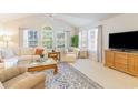 Bright living room with vaulted ceilings, large windows, and stylish furnishings at 4384 Daphne Ln. # H, Murrells Inlet, SC 29576