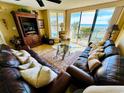 Oceanfront living room with leather sofas and large windows at 4505 S Ocean Blvd. S # 1-E, North Myrtle Beach, SC 29582