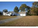 Home with a large yard and a three-car garage at 4819 Walnut St., Loris, SC 29569