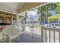 Front porch with wicker chairs and small table, overlooks other houses at 6001-1654 South Kings Hwy., Myrtle Beach, SC 29575