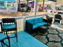 Relaxing porch with blue seating and patterned rug at 6001-1655 South Kings Hwy., Myrtle Beach, SC 29575