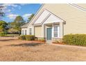 Tan siding townhome with dark green door and landscaping at 6172 Catalina Dr. # 911, North Myrtle Beach, SC 29582