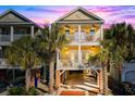 Two-story home with a brick driveway and palm trees at 116B 15Th Ave. N, Surfside Beach, SC 29575