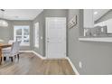 Gray walls and hardwood floors, white door to the kitchen at 184 Retreat Pl., Little River, SC 29566