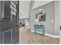 Bright and airy entryway with teal console table and hardwood floors at 184 Retreat Pl., Little River, SC 29566