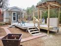 Elevated deck with seating area, fire pit, and stairs leading down at 187 Stephen Dr., Hemingway, SC 29554