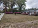 Brick ranch home with azaleas, white fence, and a spacious yard at 187 Stephen Dr., Hemingway, SC 29554