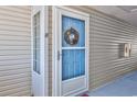 Inviting condo entry with a blue door and festive wreath at 1943 Bent Grass Dr. # H, Myrtle Beach, SC 29575