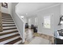 Bright and spacious entryway with wooden stairs and a view into the living area at 2360 Goldfinch Dr., Myrtle Beach, SC 29577