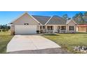 Tan house with a white garage door and small porch at 2579 Allen Dew Rd., Conway, SC 29527