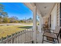 Front porch with white picket fence and seating area at 2579 Allen Dew Rd., Conway, SC 29527