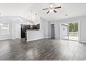 Open living room and kitchen with high ceiling and sliding glass door at 293 Foxpath Loop, Myrtle Beach, SC 29588