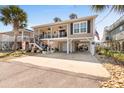 Two-story beach house with parking, elevated foundation, and American flag at 403 36Th Ave. N, North Myrtle Beach, SC 29582