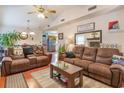 Living room with brown leather couches and a stone fireplace at 4306 Princeton Dr., Little River, SC 29566