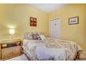 Bright bedroom features a queen-sized bed, plush bedding, neutral carpet, and closet at 4660 Lightkeepers Way # 37A, Little River, SC 29566
