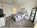 Main bedroom with king-size bed, dresser, and ensuite bathroom at 4811 Magnolia Lake Dr. # 105, Myrtle Beach, SC 29577