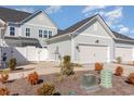 Side view of the townhome, highlighting garage and landscaping at 5353 Knobcone Loop # C-103, Myrtle Beach, SC 29577